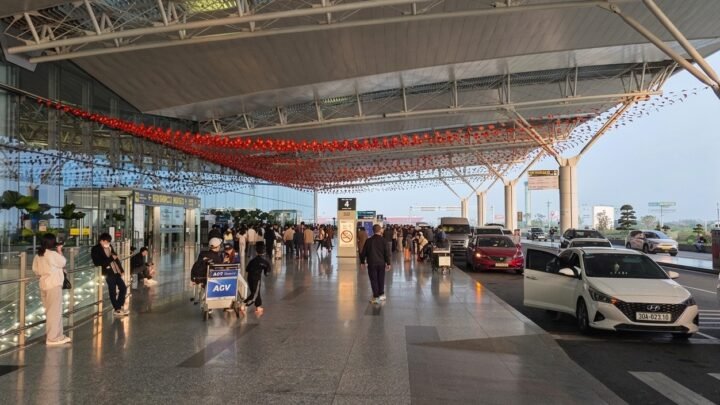 Pasajeros y coches en la terminal de salidas del aeropuerto de Hanoi.